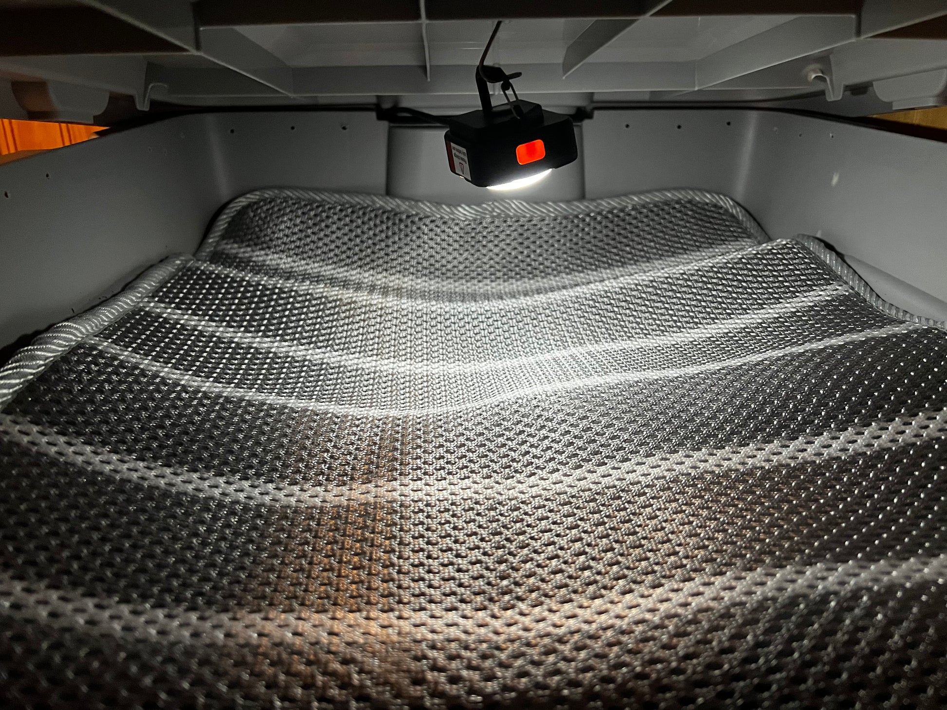 Bloom & Garden worm bedding with LED light showing textured surface under bright illumination